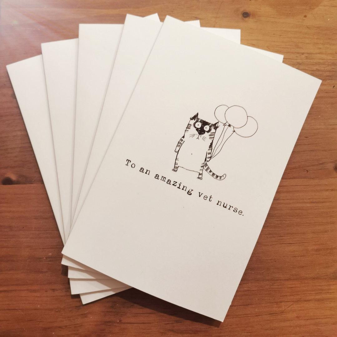 To an amazing vet nurse gift book with hand-drawn cat holding balloons, in a fanned stack of keepsake books for veterinary professionals